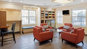 A spacious lobby with seating areas, a reception desk, and a beverage kiosk. - MainStay Suites Mt. Laurel - Philadelphia (Mount Laurel)