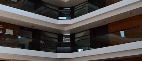 A multi-level atrium with glass railings and a central open space.