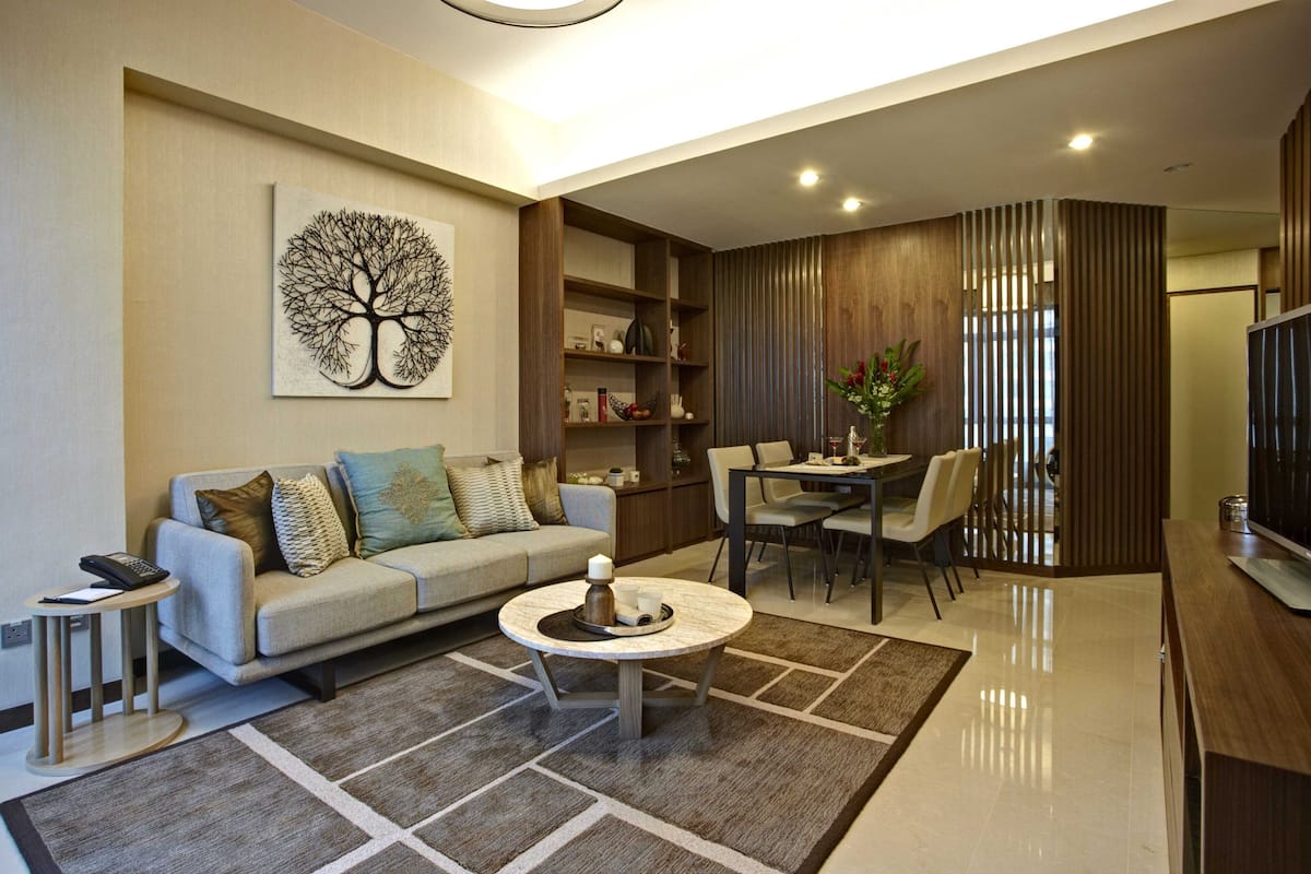 A modern living room with a sofa, coffee table, and dining area.