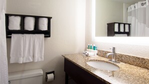 A bathroom with a sink, mirror, towel rack, and toiletries. - Holiday Inn Express Hotel & Suites Spence Lane by IHG (Nashville)