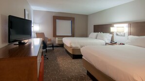 A hotel room with a TV, two beds, a desk, and a chair. - Holiday Inn Express Hotel & Suites Spence Lane by IHG (Nashville)