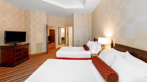 A hotel room with two beds, a television, a desk, and a lamp. - Wyndham Grand Oklahoma City Downtown (Oklahoma City)