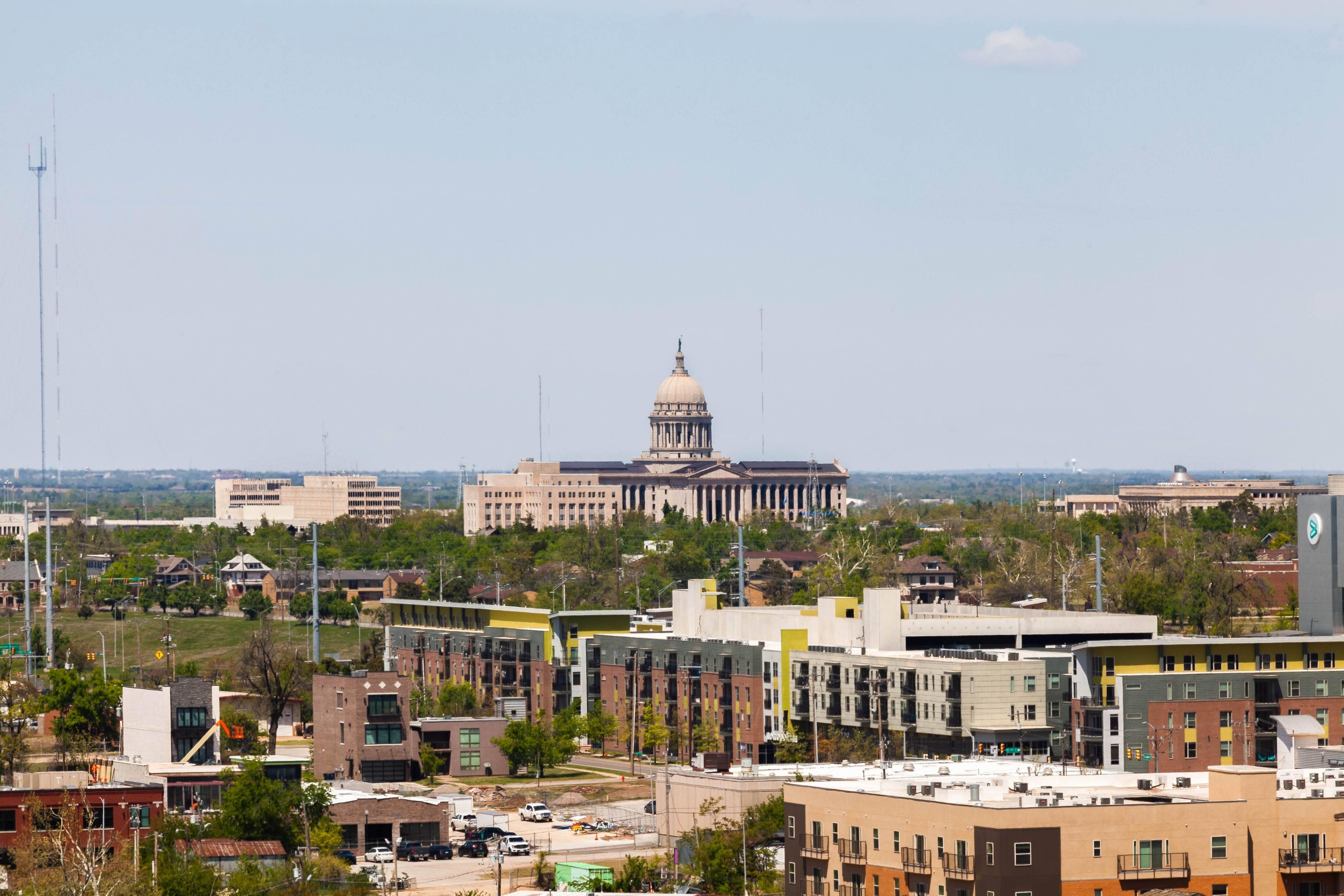 A cityscape with a prominent government building featuring a dome and columns.