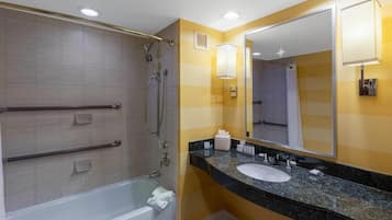 A bathroom with a shower, a bathtub, a sink, and a mirror.