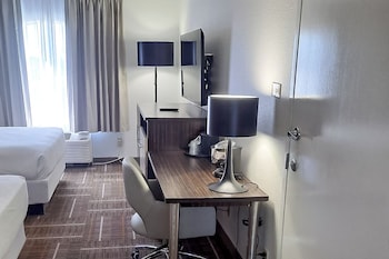 Room, 2 Queen Beds | Desk, laptop workspace, blackout drapes, iron/ironing board at Sonesta Essential Orlando