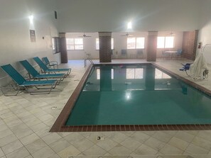 Indoor pool, open 10:00 AM to 10:00 PM, pool loungers