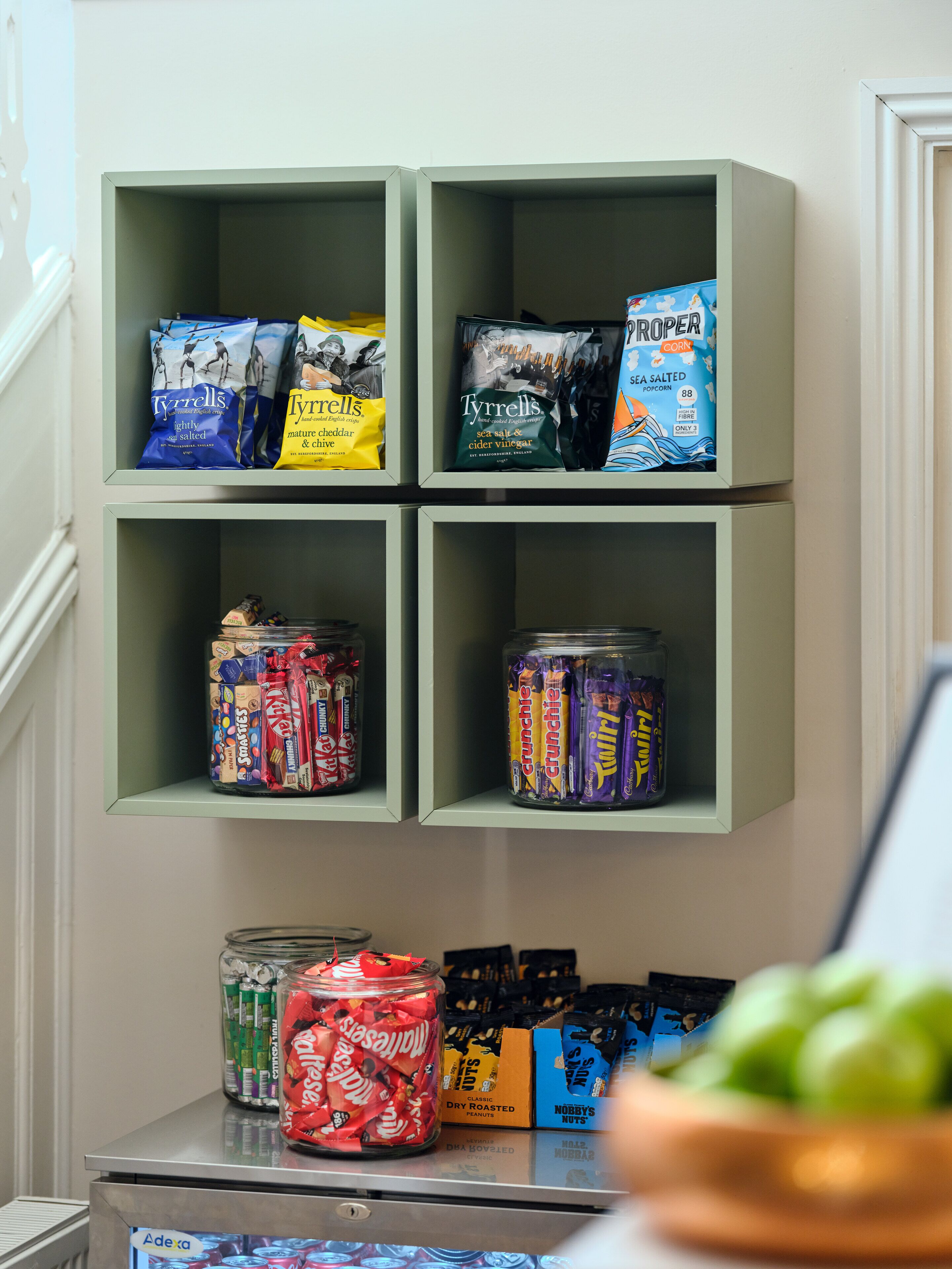A shelf with snacks and candies.