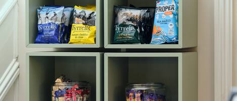 A shelf with snacks and candies.