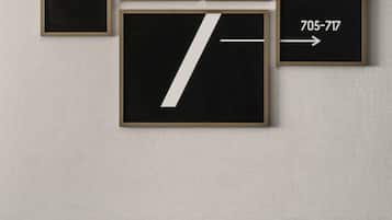 A wall with four framed signs, each displaying a number and an arrow.