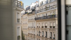 A row of historic European-style buildings with multiple balconies, large windows, and decorative moldings. - Hotel Pulitzer Paris (Paris)