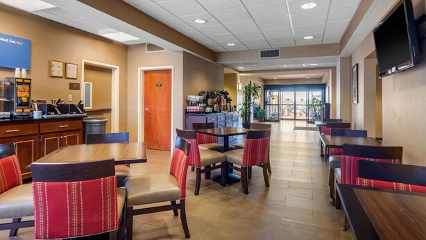 A hotel lobby with a reception desk, seating area, and a television mounted on the wall. - Comfort Inn & Suites LaGrange East (LaGrange)