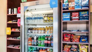 A vending machine stocked with various beverages and snacks, including sodas, juices, and chips. - Comfort Suites Miamisburg - Dayton South (Miamisburg)
