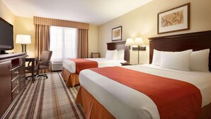 A hotel room with two beds, a desk, a TV, and a chair. - Country Inn & Suites by Radisson, Lexington, VA (Lexington)