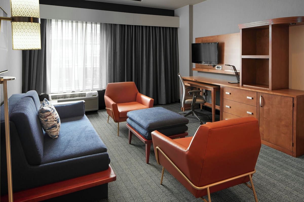 Suite, 1 King Bed with Sofa bed | Living area | 32-inch LCD TV with cable channels, TV