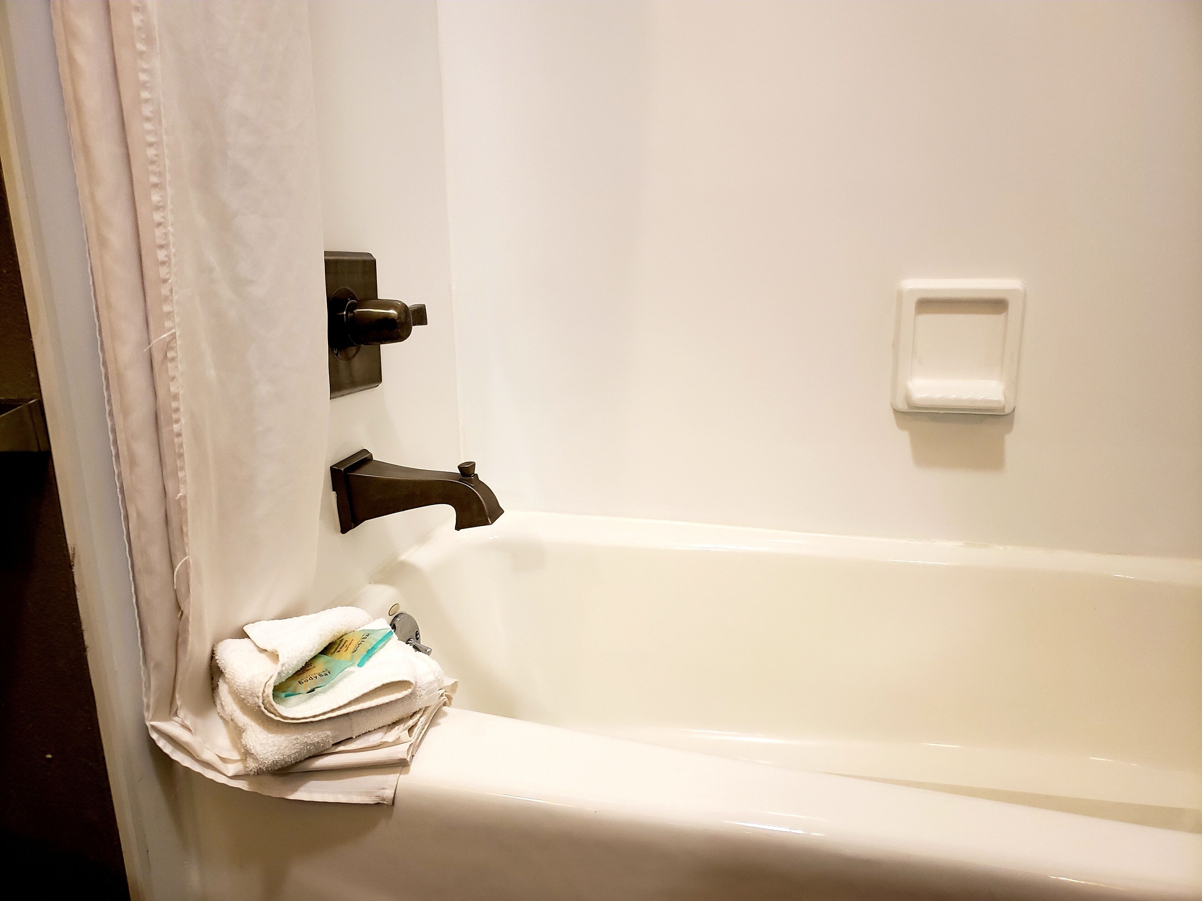 combined shower/bathtub, eco-friendly toiletries, hair dryer, towels