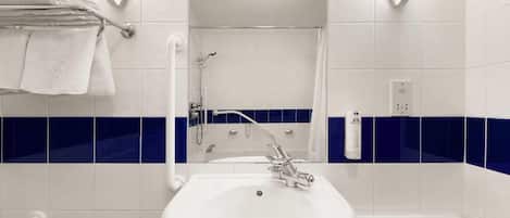 A bathroom with a white sink, a towel rack, and a shower.