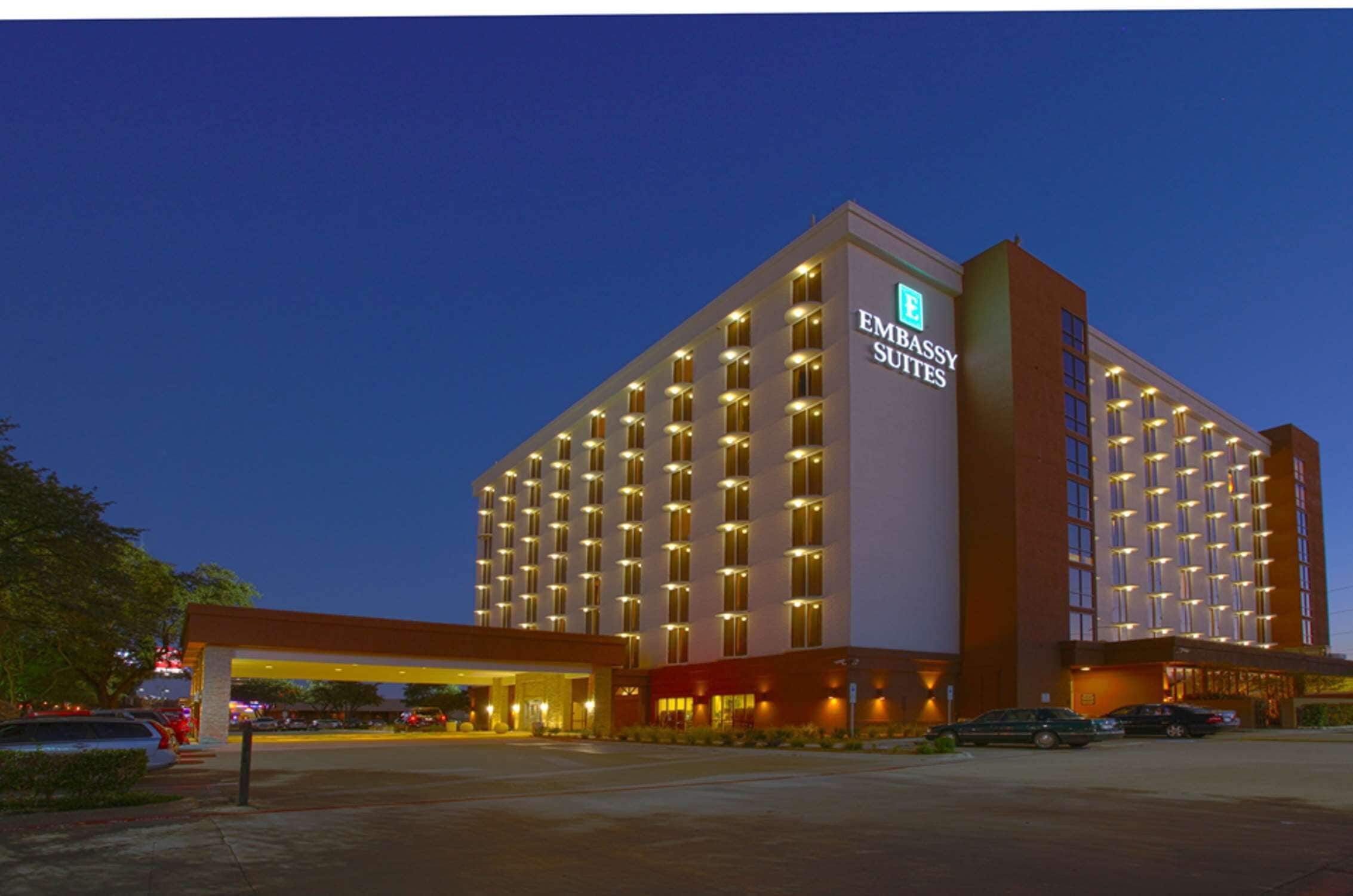 A large, multi-story hotel with a prominent sign reading "EMBASSY SUITES."
