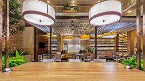 A spacious conference room with a long wooden table, multiple chairs, and ambient lighting. - Embassy Suites by Hilton Dallas Market Center (Dallas)