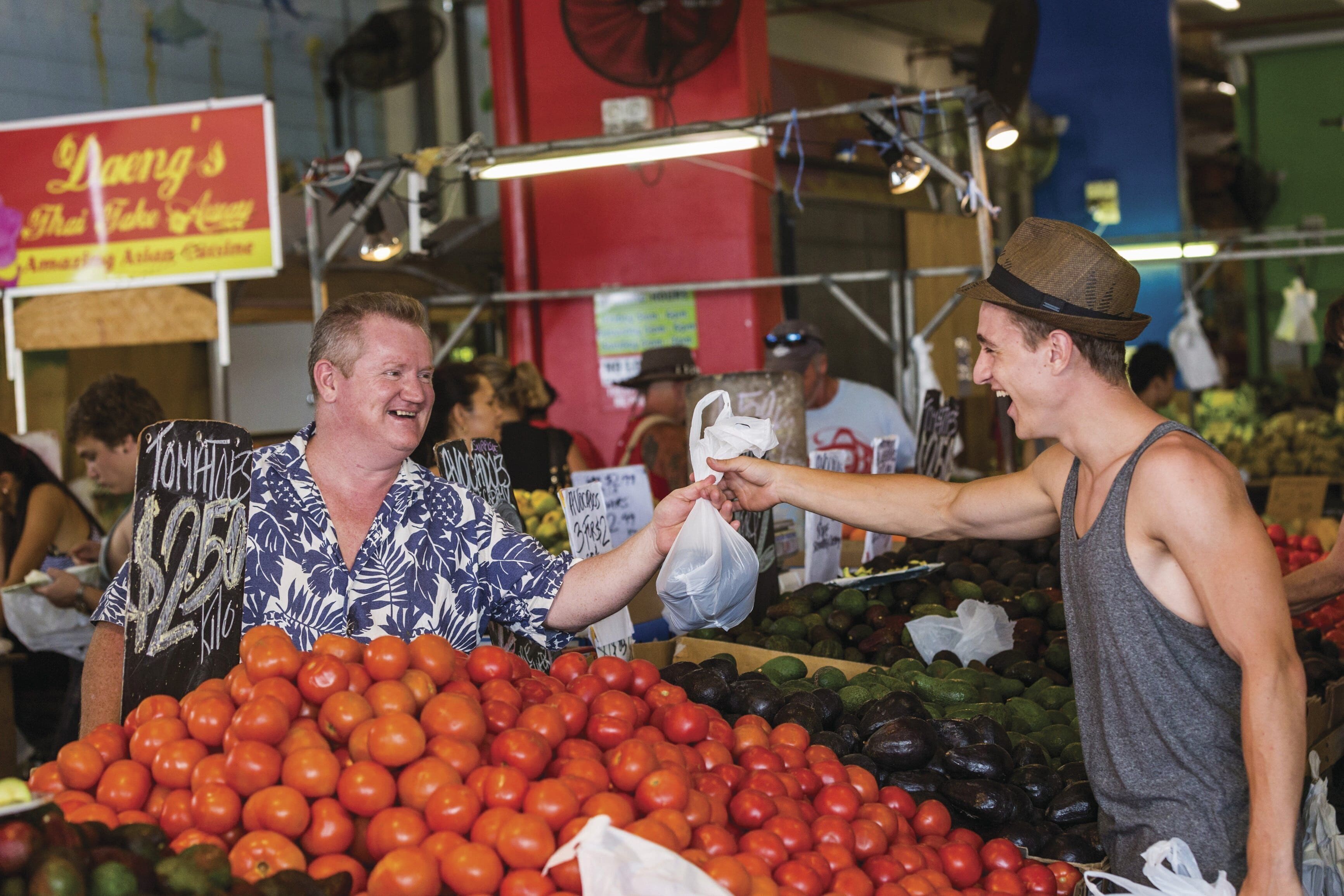 A market with a variety of fresh produce, including tomatoes and avocados.