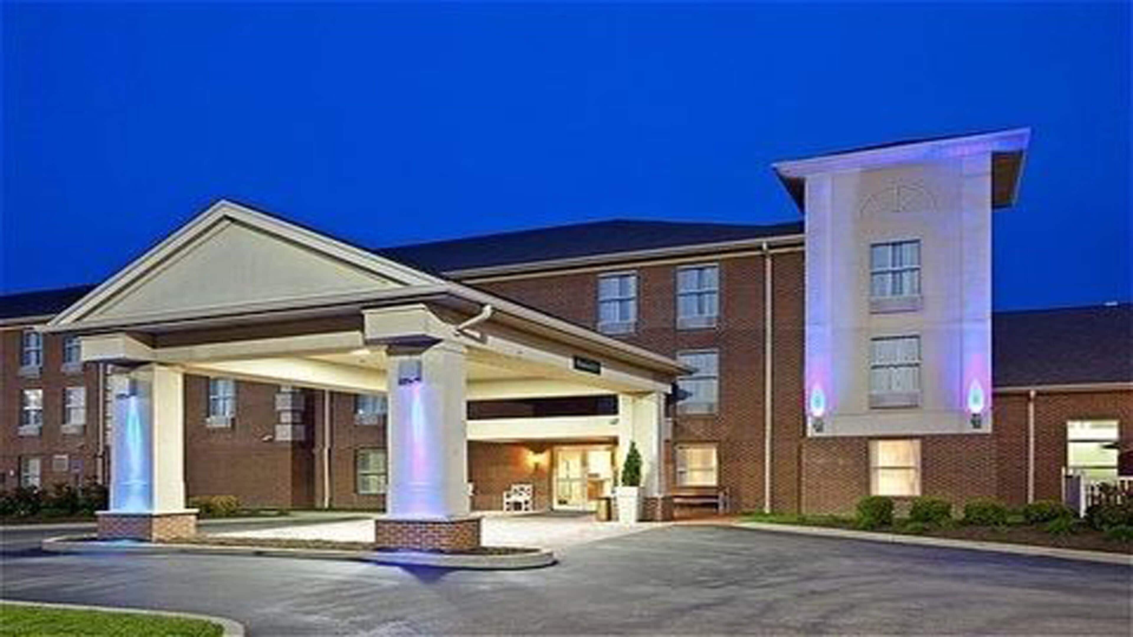 A hotel with a covered parking area and a prominent entrance.