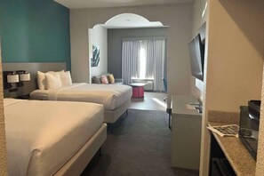 A hotel room with two beds, a desk, a TV, and a window with curtains. - Comfort Inn & Suites Burnet (Burnet)