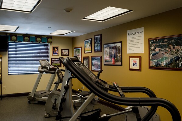 A fitness center with exercise equipment, framed pictures on the walls, and a sign indicating the center's name. - Holiday Inn Express Hotel & Suites Oxford by IHG (Oxford)