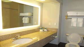 A bathroom with a sink, mirror, towel rack, and toilet. - Holiday Inn Express Hotel & Suites Oxford by IHG (Oxford)