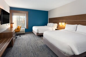 A hotel room with two beds, a desk, a chair, a TV, and a window with a view of trees. - Holiday Inn Express New Albany - Louisville NW by IHG (New Albany)
