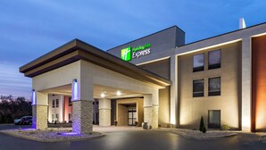 A Holiday Inn Express building with a modern design, featuring a prominent entrance and a well-lit facade.