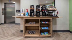 A hotel reception area with a coffee station, a water dispenser, and a fire extinguisher. - Extended Stay America Suites DC Fairfax Fair Oaks Mall (Fairfax)