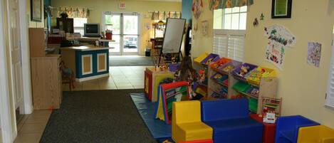 A children's play area with colorful foam blocks, a play mat, and educational toys.