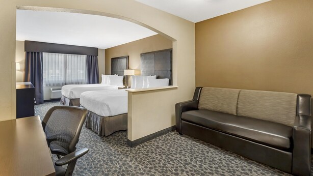 A hotel room with a bed, a sofa, a desk, and a chair. - Best Western Plus Aberdeen (Aberdeen)