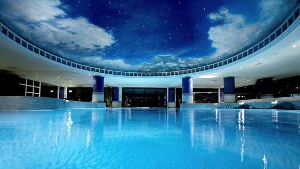 A large indoor swimming pool with a ceiling simulating a starry night sky. - Celtic Manor Resort (Newport)