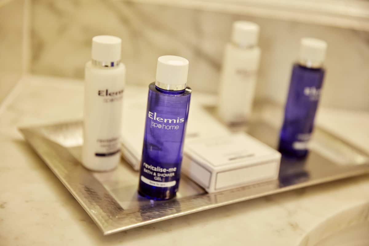A tray with various toiletries including Elemis and Elemis Spa@Home products.