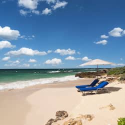 On the beach, white sand, sun loungers, beach umbrellas