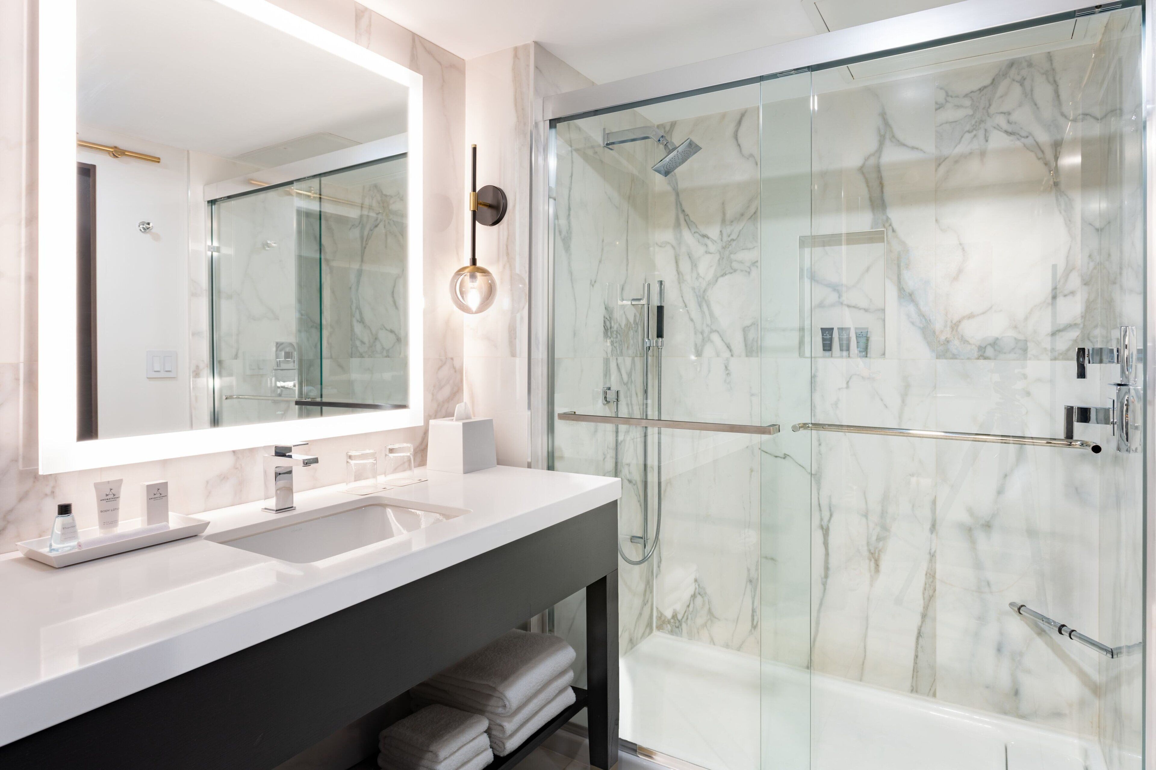 combined shower/bathtub, designer toiletries, hair dryer, bathrobes