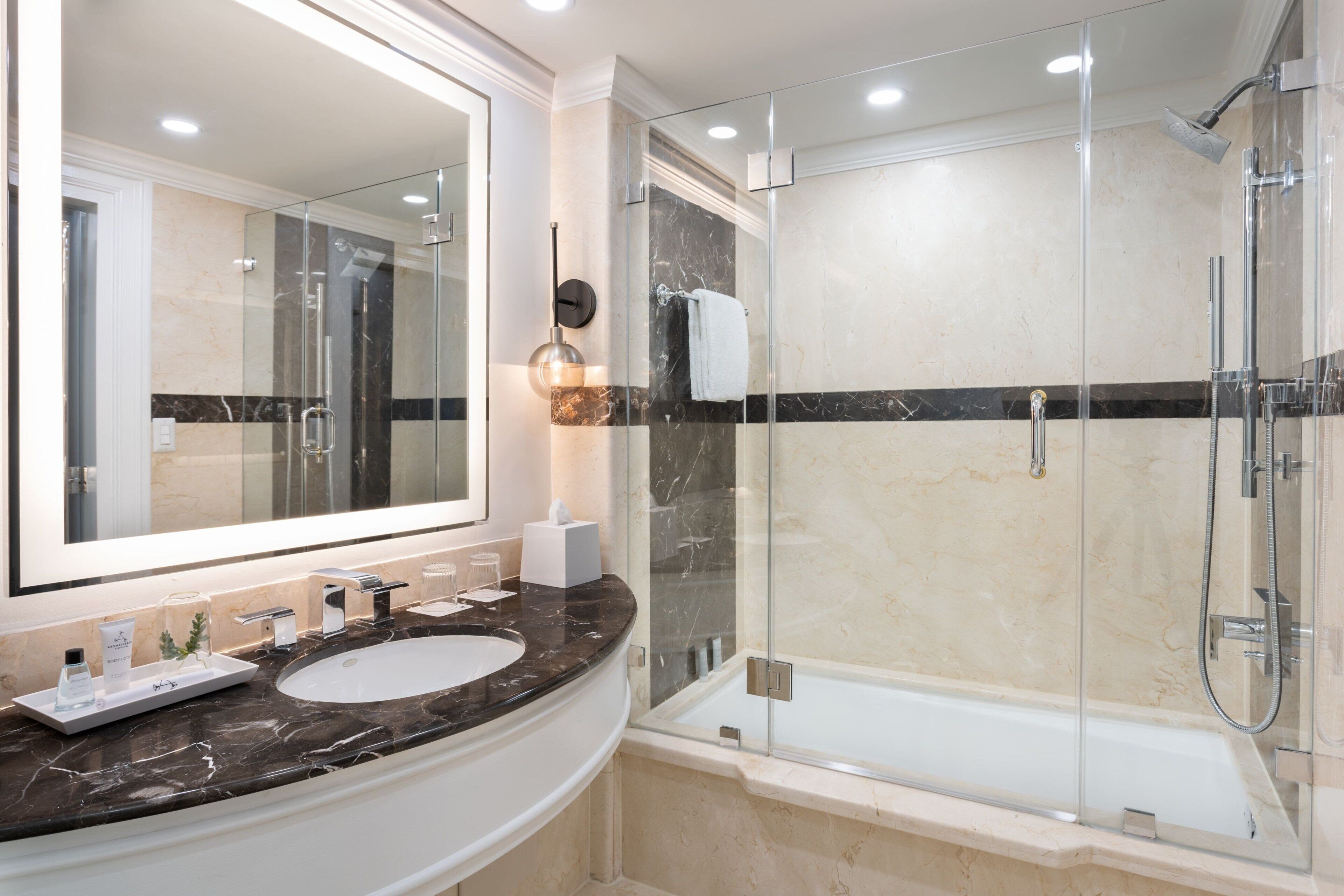 combined shower/bathtub, designer toiletries, hair dryer, bathrobes