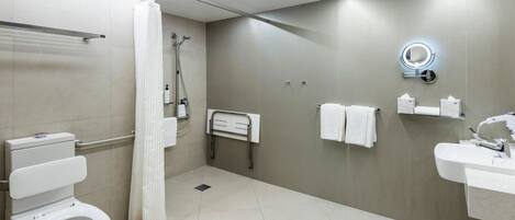 Un baño moderno con inodoro, ducha y lavamanos.