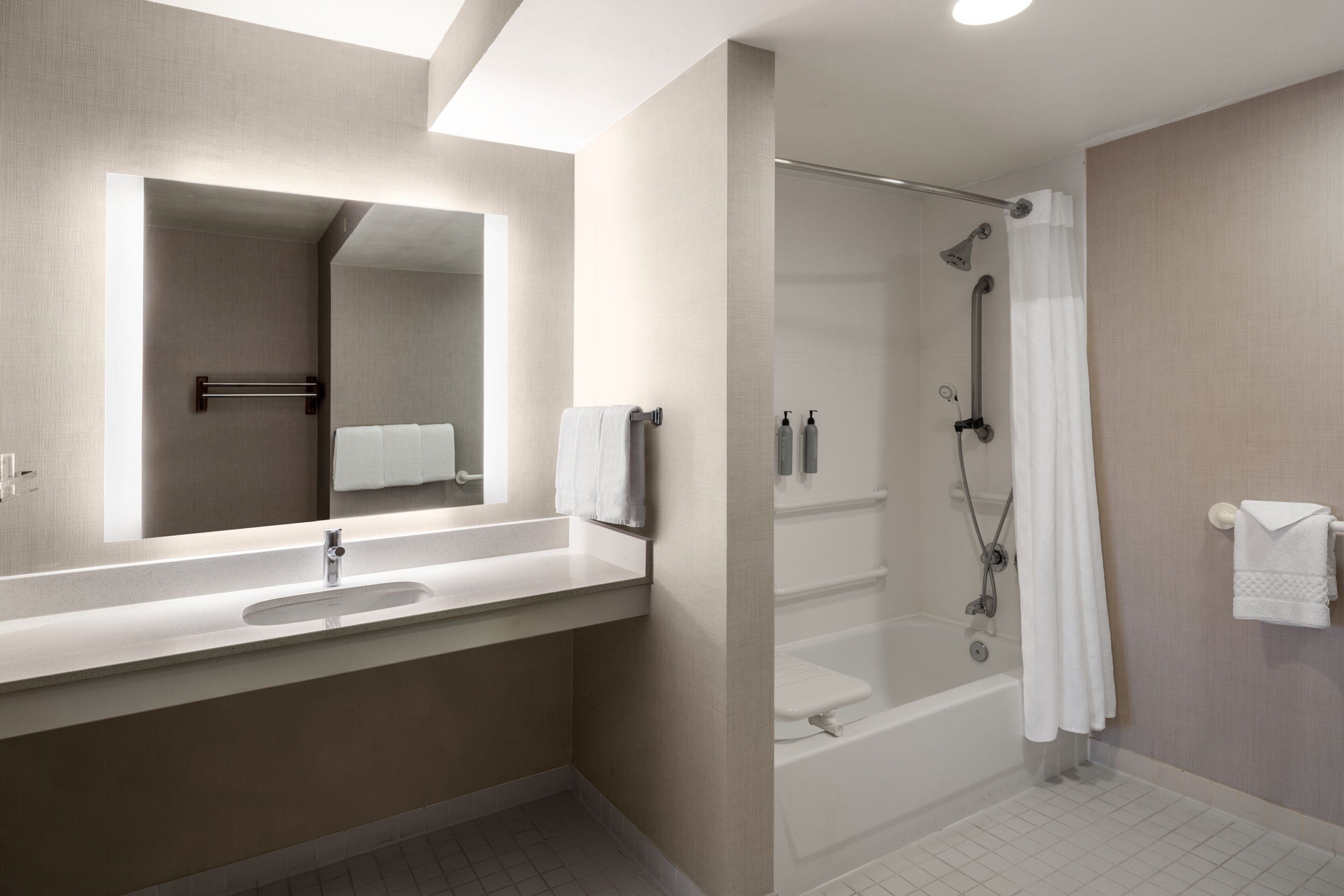 combined shower/bathtub, designer toiletries, hair dryer, towels