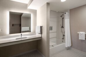 Combined shower/bathtub, designer toiletries, hair dryer, towels