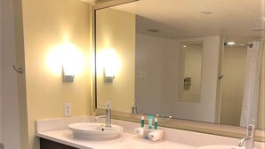 A modern bathroom with two sinks, a large mirror, and a towel rack. - Holiday Inn Express Indianapolis-Fishers by IHG (Fishers)