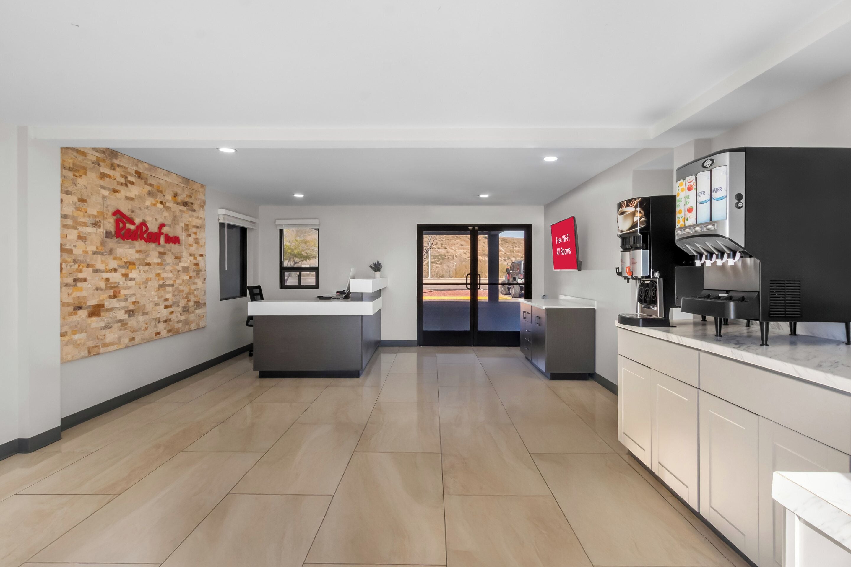 A modern kitchen with a coffee machine, a counter, and a wall-mounted sign.