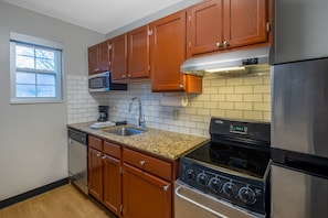 Suite, 2 Bedrooms | Private kitchen | Full-sized fridge, microwave, oven, stovetop