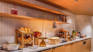 A well-organized buffet with various food items and a coffee station. - Citadines République Paris (Paris)