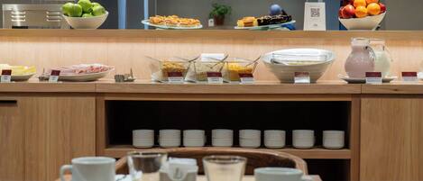 A breakfast buffet with various food items and beverages.