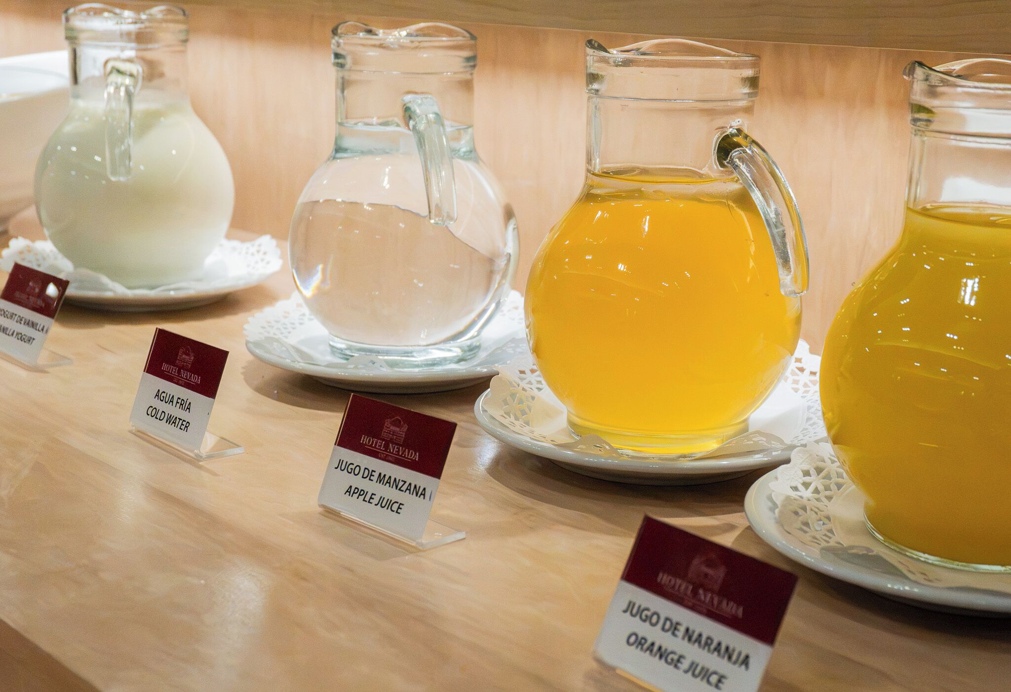 A selection of beverages in glass containers with labels indicating their names and types.