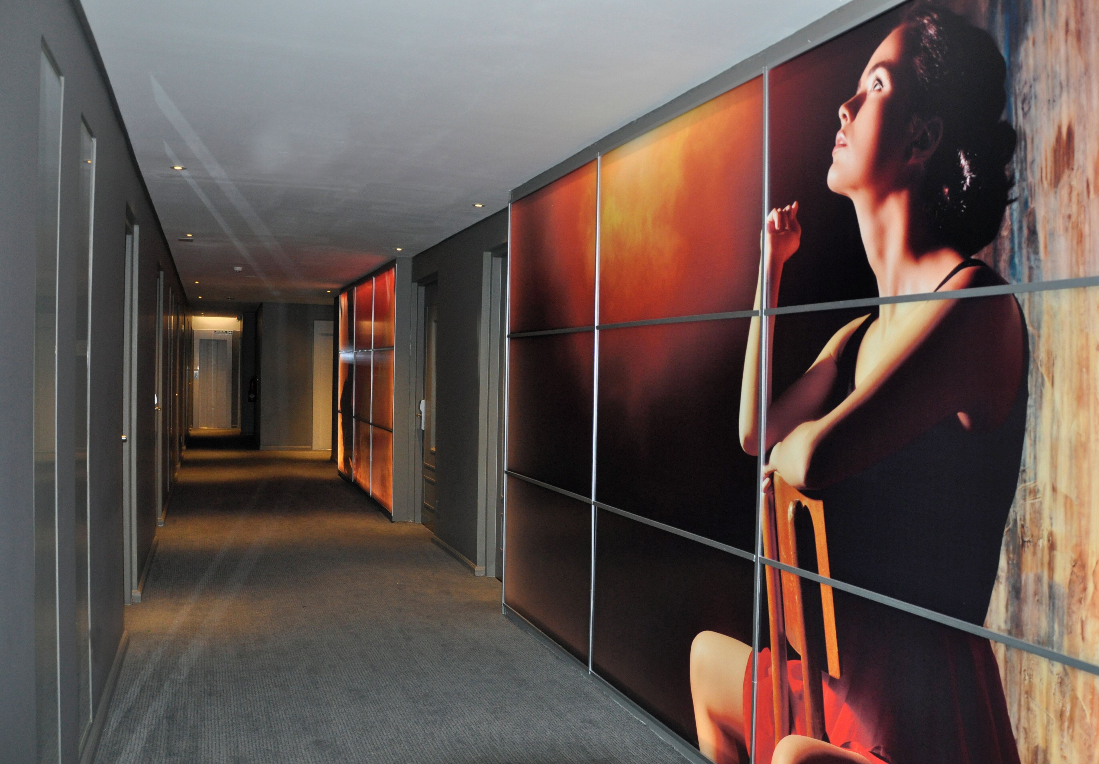 A corridor with a large advertisement featuring a person.