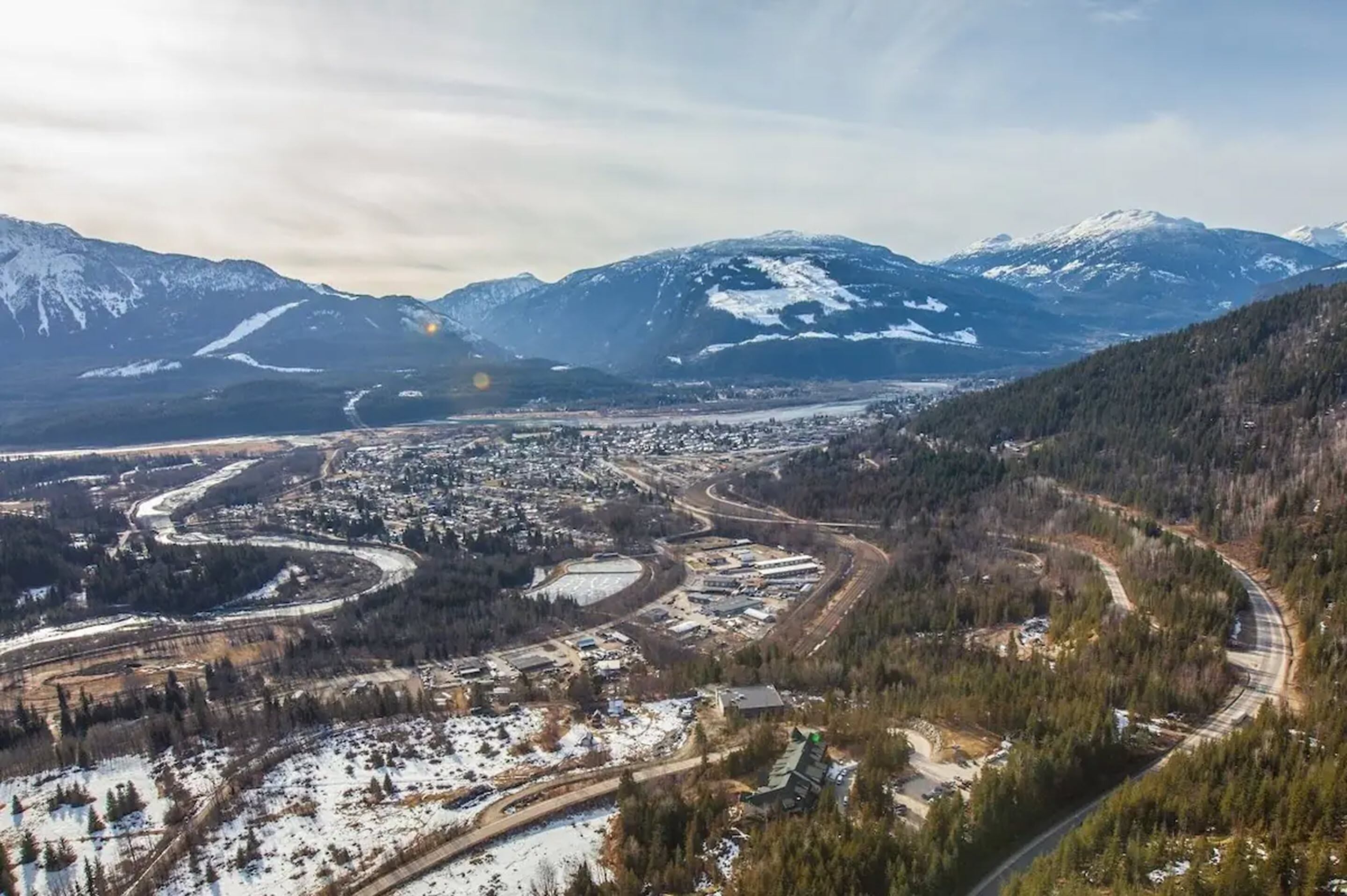 A mountainous landscape with a winding road and a small town.