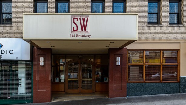 A building with a sign reading "SW 615 Broadway" and a storefront with a sign that says "EYE STUDIO". - SW Hotel – No Resort Fee (San Francisco)