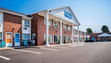 A Travelodge hotel with a brick facade, multiple windows, and a covered entrance.